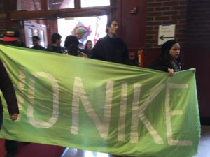 Students bring a banner from the rally in Dalhgren Quad to the President's foyer. Photo: Lilah Burke