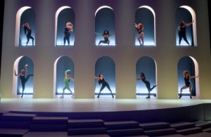 impressive North African-inspired set design, complete with a circular pool and blocks, multiple staircases and buildings. Source: WWD