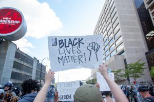 A person holds up a sign at a march saying "Black Lives Matter."