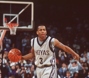 Allen Iverson dribbling the ball and wearing Georgetown's iconic kente cloth jersey.