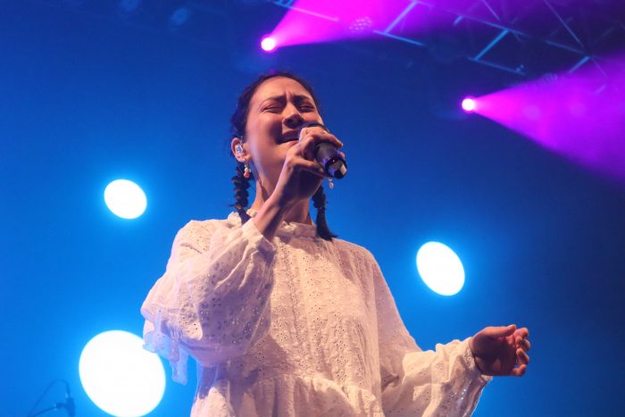 Michelle Zauner in a white dress singing at the Fillmore Silver Spring on July 21.