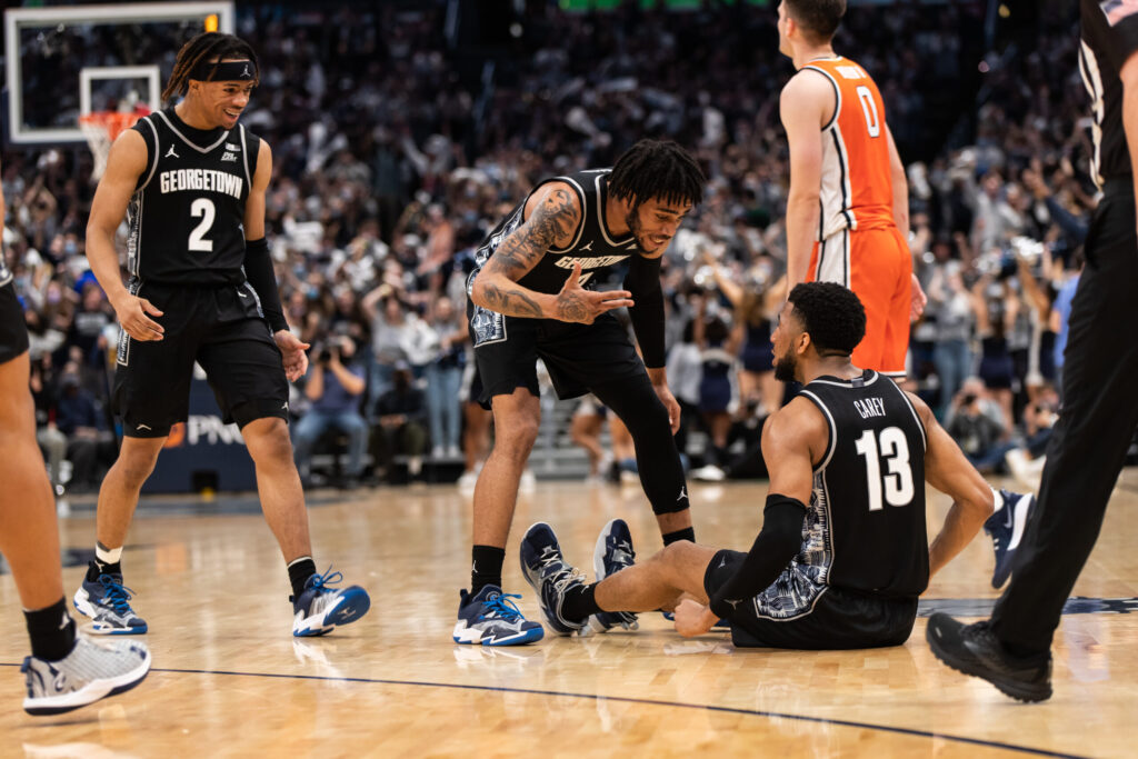Kaiden Rice and Dante Harris celebrate Donald Carey's three-pointer.