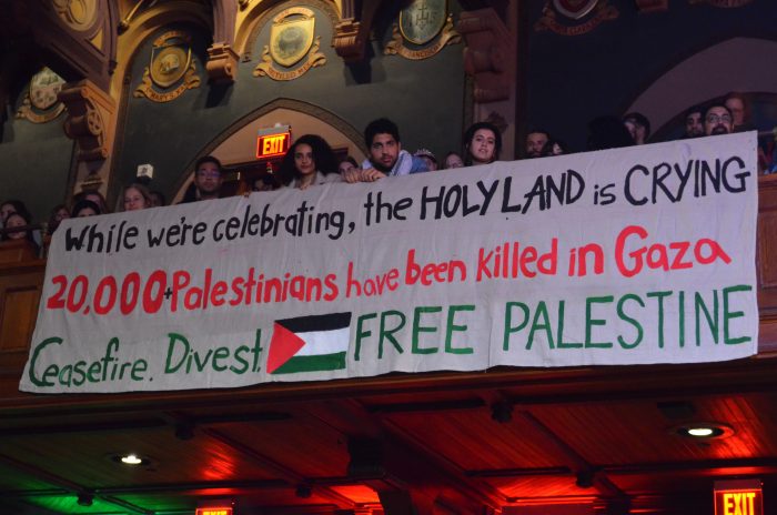 Banner at the Xmas tree lighting with the words: "While we're celebrating the holy land is crying. 20,000+ Palestinians have been killed in Gaza. Ceasefire. Divest. Free Palestine."
