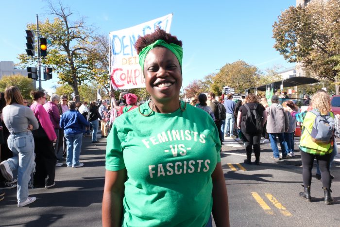 Middleton stands in a green shirt, smiling in front of the really