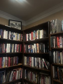 Two dark wood bookshelves meet in a corner of the Lantern Bookshop.