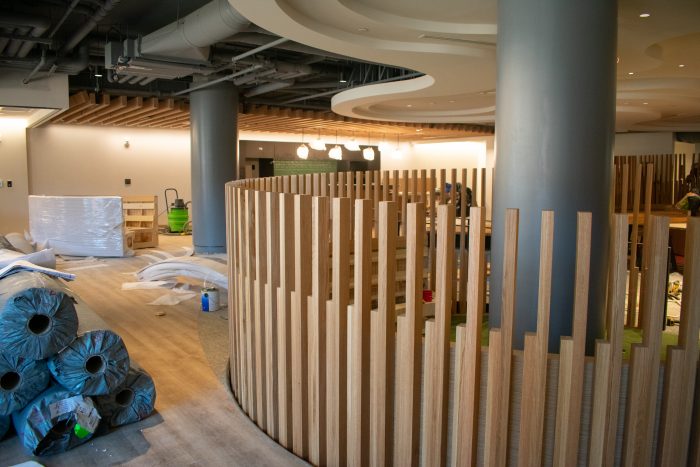 Construction on the circular conversation pits, featuring wooden accents.