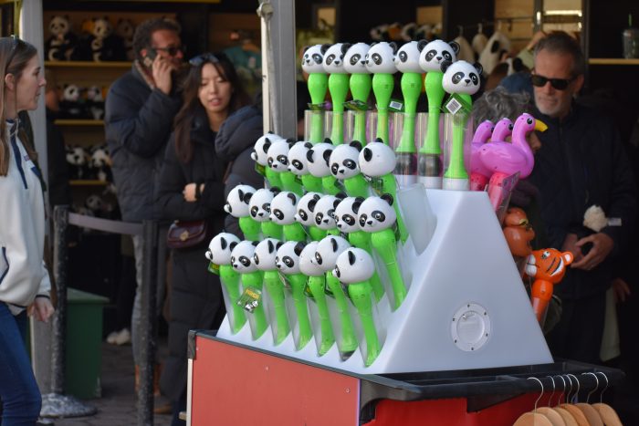 Green toy microphones with panda heads on the top are on display for sale at the zoo.