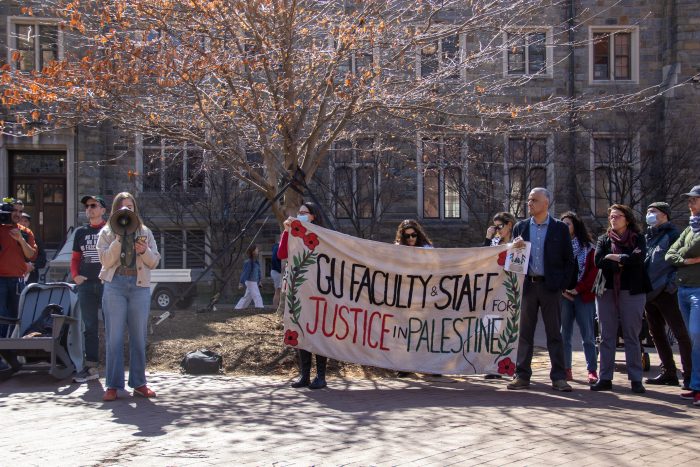 Zeytoun organizer speaking into a megaphone beside FSJP members, including Fida Adely.