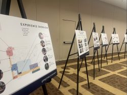 Multiple boards displayed with maps, design plans, and general information about the upcoming hotel renovations.