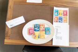 Book-cover inspired cookies next to the source material, on a brown table.